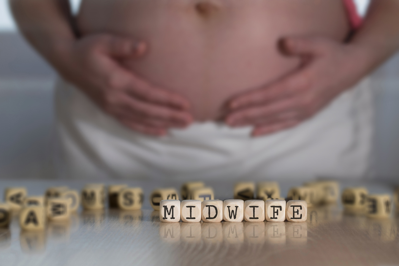 Word MIDWIFE  composed of wooden letters.